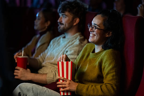 istock Hispanic Couple Enjoying Cinema Experience with Popcorn 2239910609