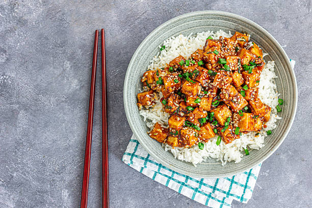 istock Stir-Fried Tofu Over Rice Garnished with Scallion Directly Above Photo 2239911557