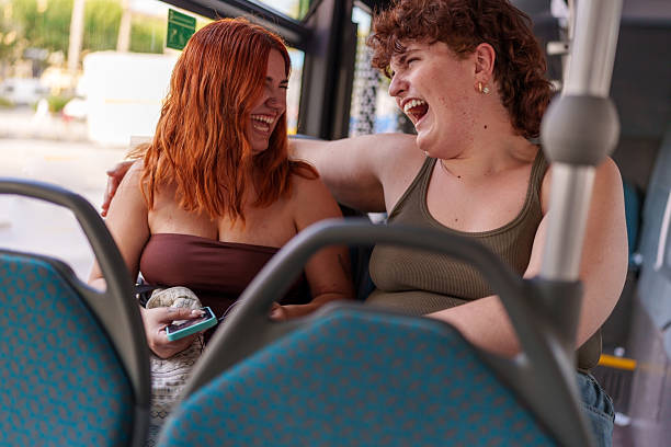 istock Friends laughing together riding public public transportation 2239912110