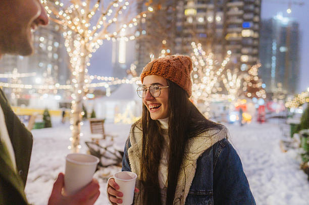 istock Young couple drinking mulled wine at Christmas market 2239912290