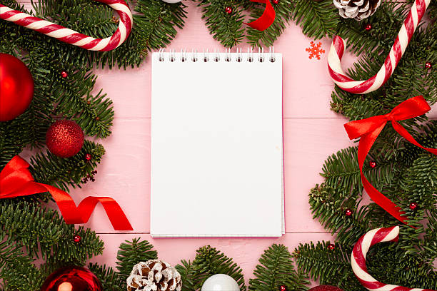 istock Festive Christmas tree branches with notepad on wooden background, top view 2239913490