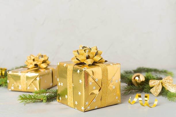 istock Golden gift box with christmas decor on concrete background 2239913564