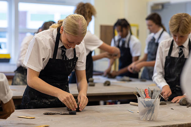 istock Happy Students Participating in Pottery Workshop at School 2239915817