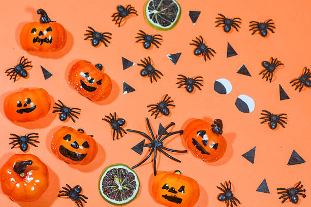 istock Background with a Halloween theme, with scary ghosts, lollipops and scary pumkins. October is the month of ghosts 2239915932