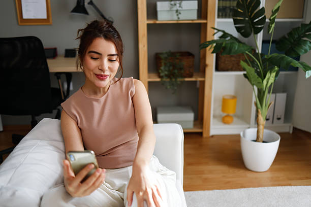 istock Woman relaxing at home using smartphone 2239916918