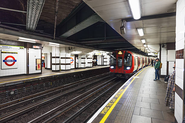 Arriving Underground train at a London Tube platform with safety line and signage. London, UK, 26 May 2023