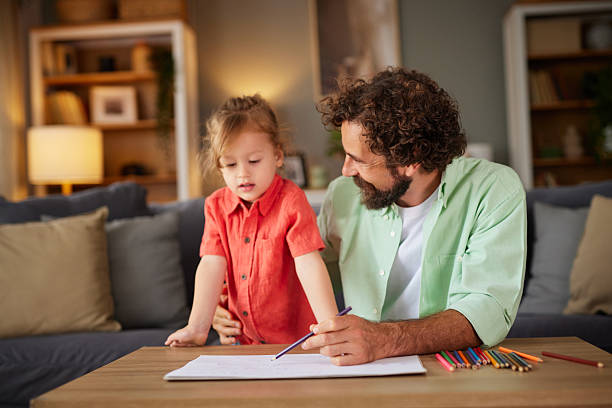 istock Father and child bonding while drawing at home 2239919879