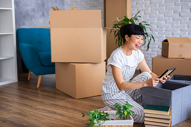 istock Woman holding a picture frame during home moving, remembering old memories 2239924410