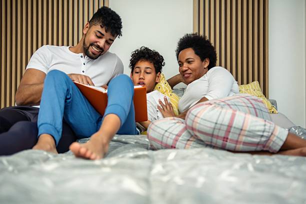 istock Family reading a book in bed 2239924723