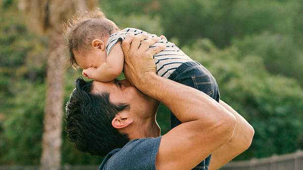 istock Loving Father Playing With Baby Son Outdoors in Garden 2239925067
