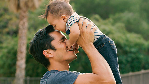istock Loving Father Playing With Baby Son Outdoors in Garden 2239925073