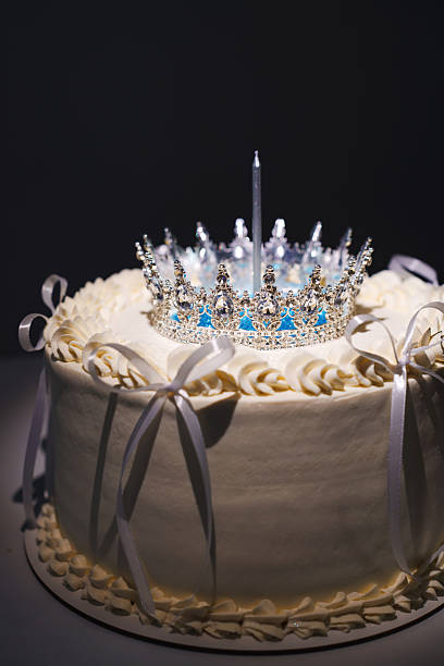 istock Elegant cake with crown and candle for a special celebration 2239925577