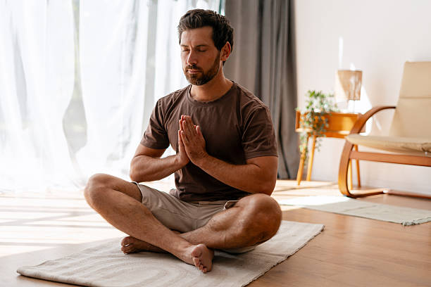 istock Latin bearded middle aged man practicing mindful meditation in peaceful home setting 2239926001