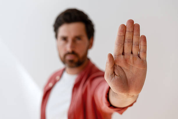 istock Serious handsome Latin man making stop gesture with open hand selective focus, closeup 2239926085