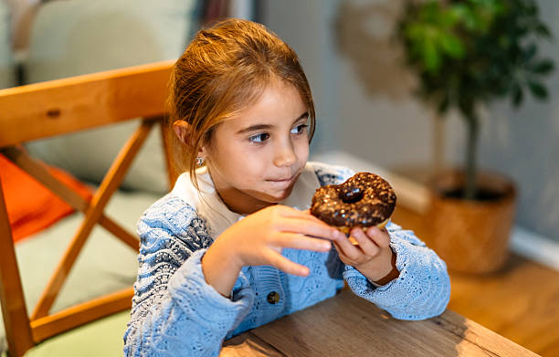 Girl eating a donut at home