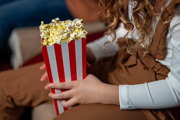 istock Young Girl Holding Popcorn at Cinema 2239930205