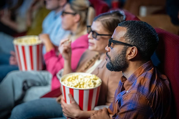 istock Friends Engrossed in 3D Movie Experience with Popcorn 2239930231