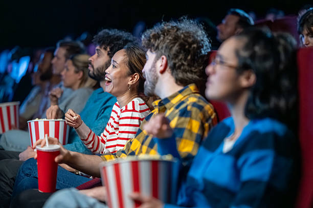 istock Group Watching Movie in Cinema with Joyful Expressions 2239930253