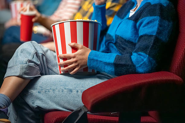 istock Person Enjoying Popcorn in Cinema Setting 2239930254