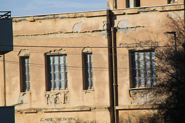 old traditional Sicilian house with split windows and peeling plaster