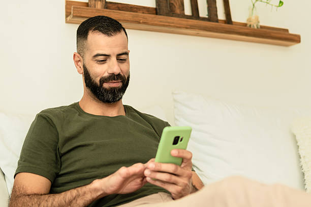 istock man with finger amputation relaxing at home and using cell phone 2239933635