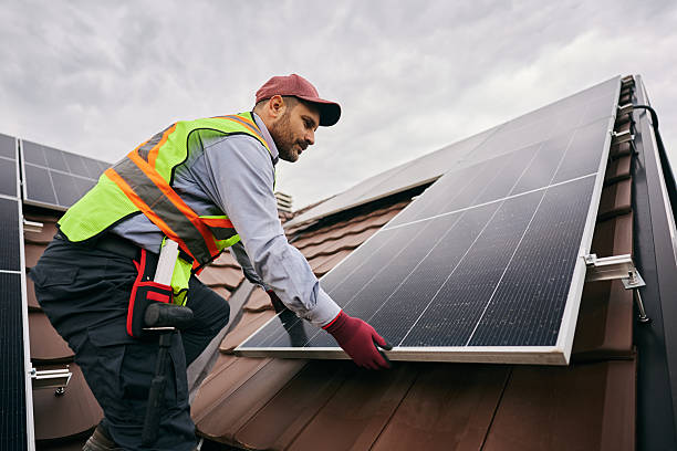 istock Male technician installing photovoltaic solar panels on the roof. 2239934207