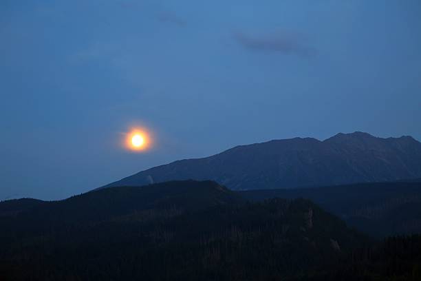 istock Golden sunset over dark mountain peaks at dusk 2239934266