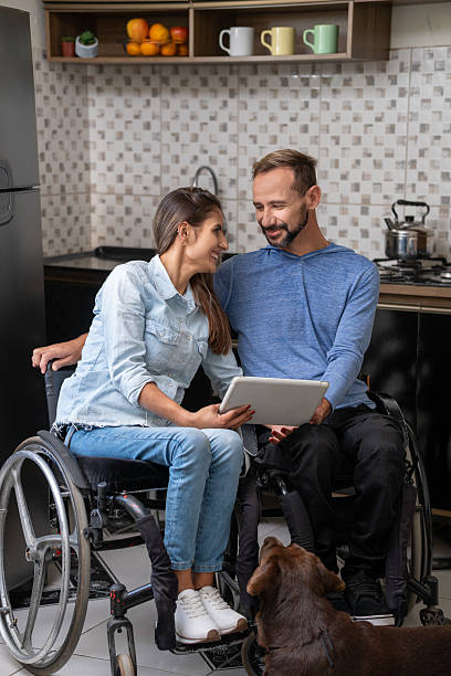 istock lovely disabled couple looking at each other holding tablet 2239935250