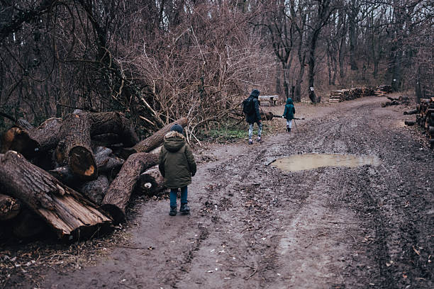istock Children hiking forest path during a muddy day 2239938001