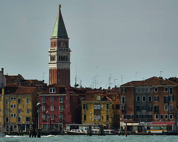 Venice cityscape featuring colorful buildings and the iconic Campanile di San Marco under a clear sky.