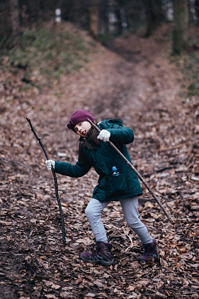 istock Girl hiking forest path with walking sticks 2239938170