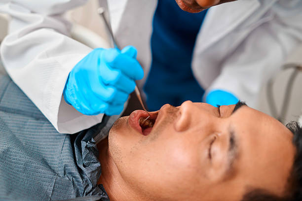 istock Gloved Dentist Performs Dental Procedure While Examining Patient In Clinic Setting During Oral Checkup Today 2239940223