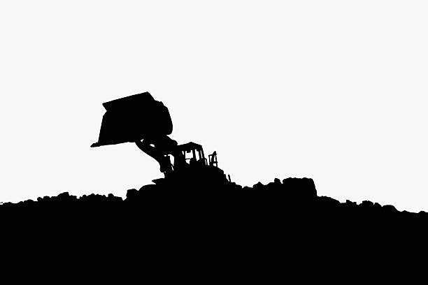 Wheel loader silhouette are digging soil with bucket lift up in the construction site on white  background