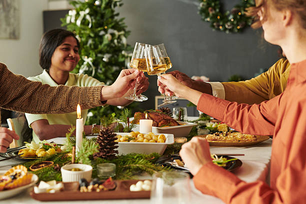istock Diverse Young Adults Celebrating Holiday Toasting Wine Glasses Around Table 2239942043
