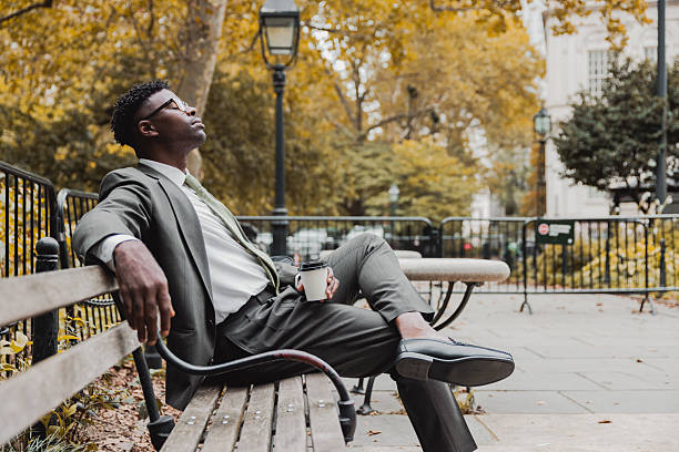 istock Businessman resting on a park bench 2239942605