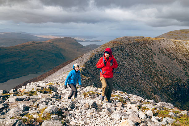 Mother and son climbing Ben Damph in the Torridon region of Scotland.
