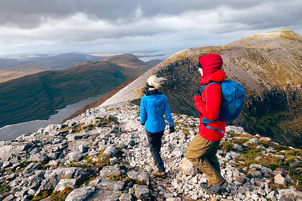 Mother and son climbing Ben Damph in the Torridon region of Scotland.