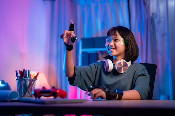 istock Girl wearing virtual reality headset enjoys gaming experience while using hand controllers in a colorful room 2239945309