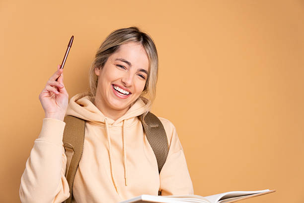 istock happy university student raising hand to question answer in studio shot. learn, school, student life concept. 2239945327