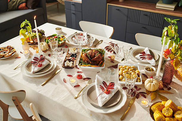 istock Thanksgiving Table Setting Featuring Roast Turkey and Autumn Harvest Decorations 2239947590