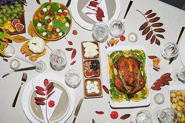 istock Overhead View of Thanksgiving Table Setting Featuring Roasted Chicken and Autumn Decor 2239947815
