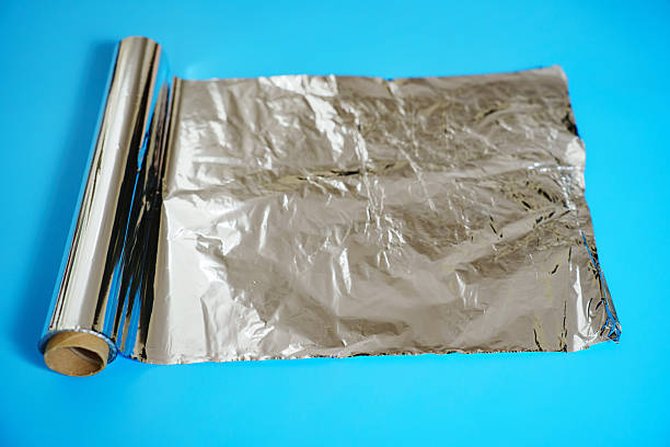 istock A roll of baking foil on a blue background. 2239947958