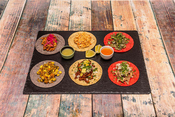 istock black slate tray with assorted Mexican tacos with dips and lime wedges 2239948565