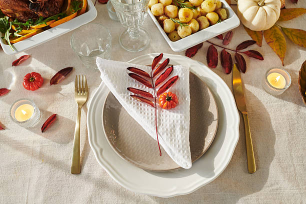 istock Thanksgiving Autumn Table Setting Featuring Decorative Leaves and Mini Pumpkin 2239948579