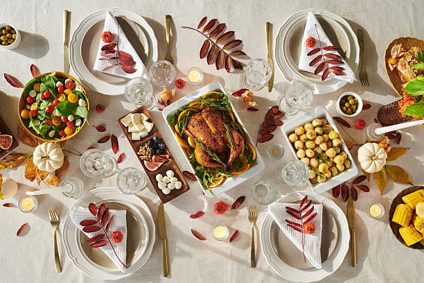 istock Overhead View of Thanksgiving Holiday Dinner Table Featuring Roast Turkey 2239949090