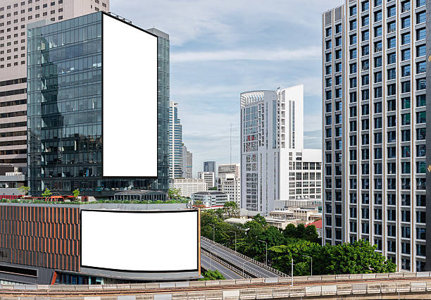 istock Two white mock up vertical and horizontal large LED display billboard on  building with cityscape view background .Clipping path for mockup 2239950478