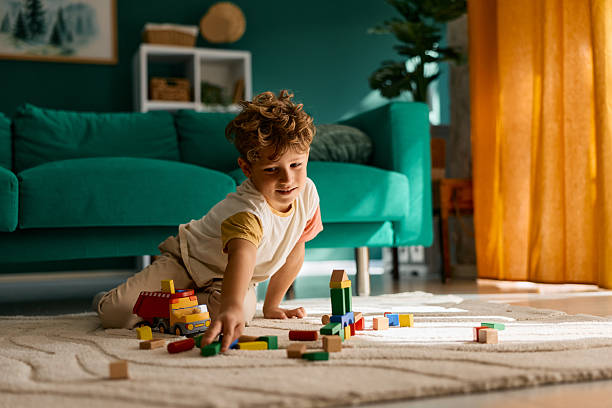 istock Child boy playing with wooden blocks at home 2239951698
