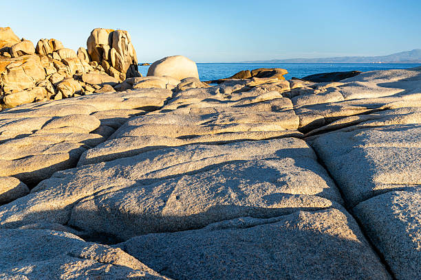 At Capo Testa, near Santa Teresa Gallura, there are enormous granite boulders overlooking the Strait of Bonifacio, countering the often rough sea. Early in the morning, the sun casts lines and patches of shadow along these enormous rock formations.