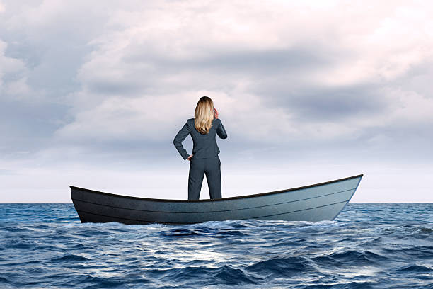istock Woman In Stranded Boat Make Cell Phone Call 2239957286