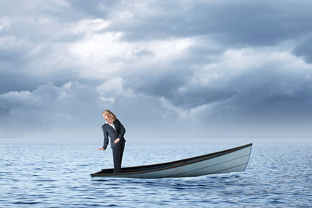istock Woman Realizing Her Boat Is Sinking 2239957297